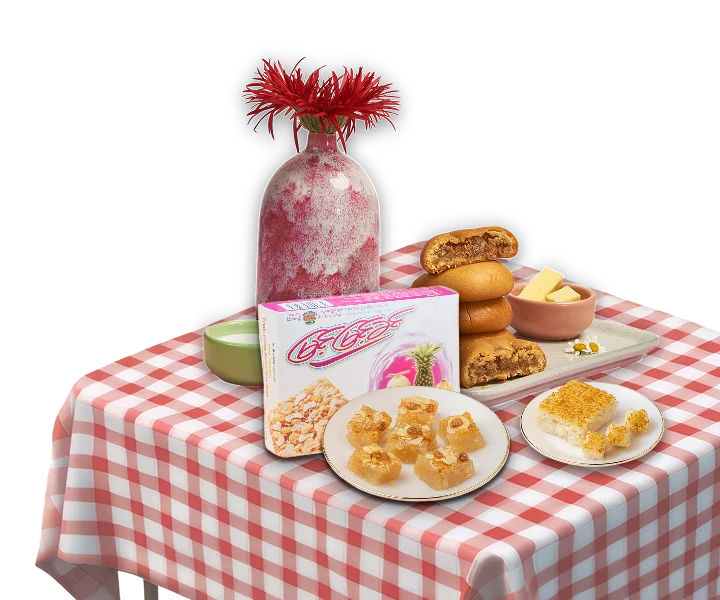 A spread of Myint Myint Khin sweets on a checked tablecloth — boxed products, sliced cakes and a plate of golden pieces